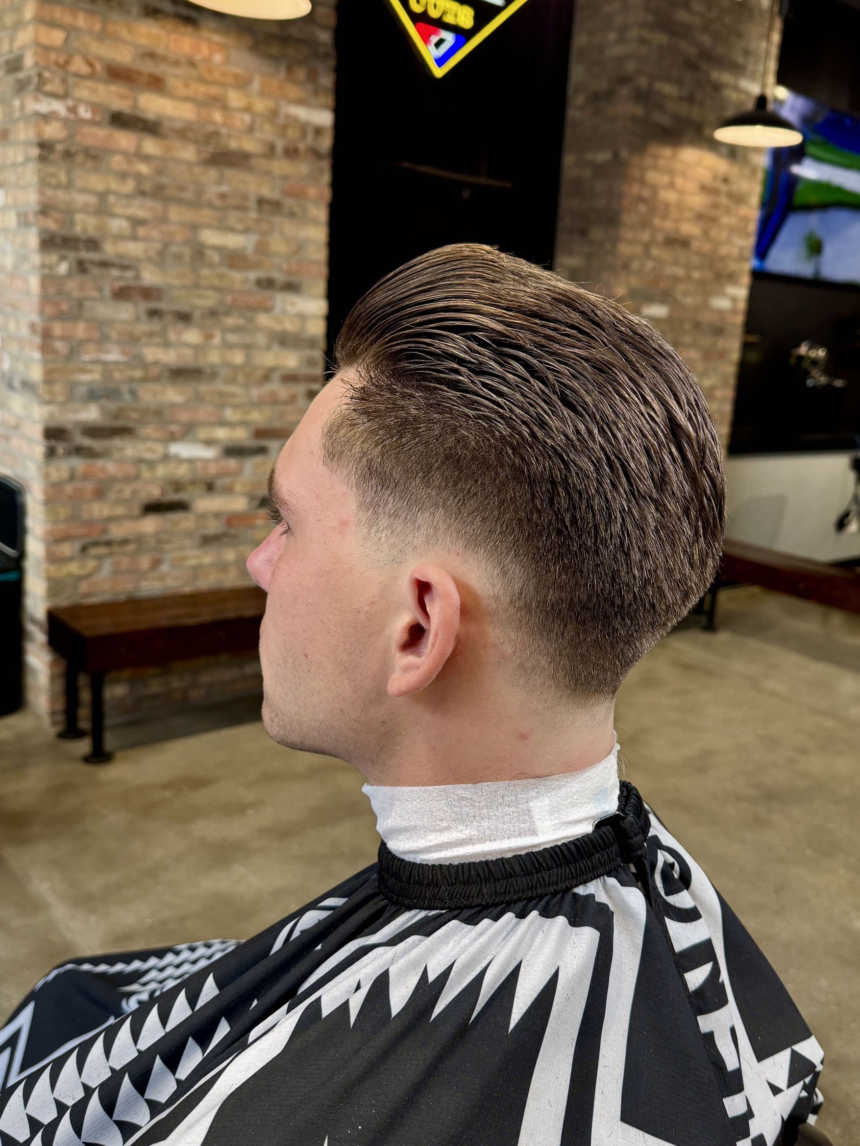 Slicked-back taper cut, back view