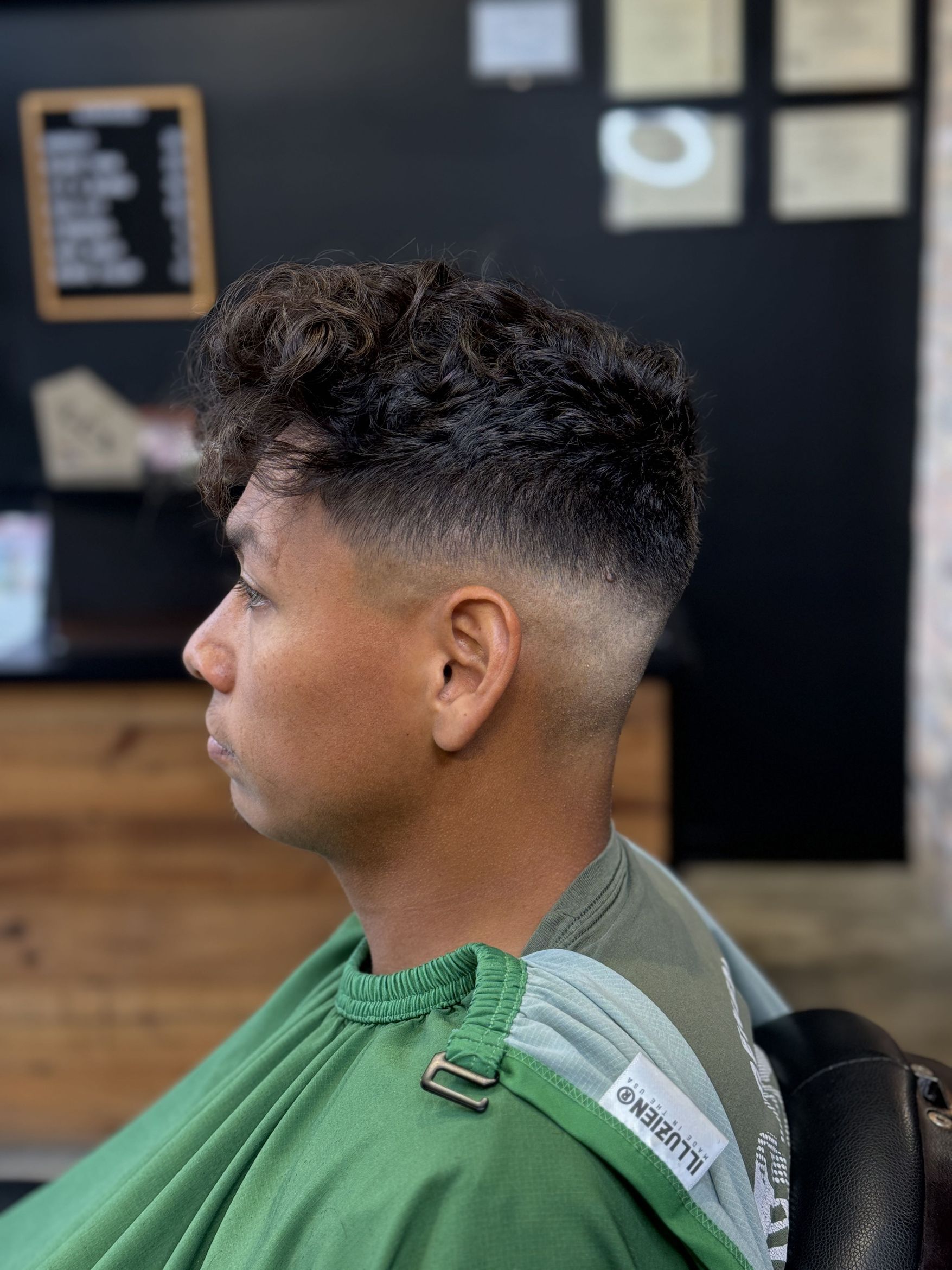 Curly top with a high skin fade